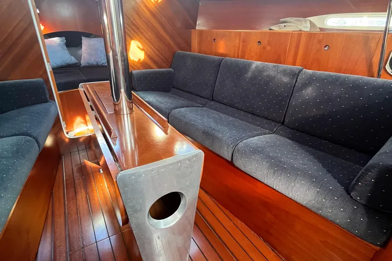 Slide: The Image of Interior of 1994 Beneteau First 35s7 yacht with elegant wood finish and cozy seating. - 47