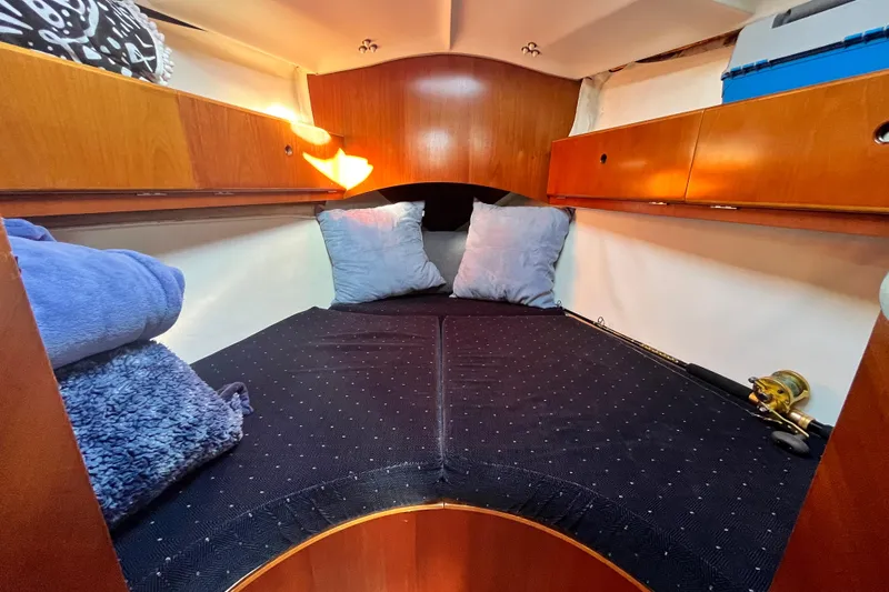 Slide: The Image of Cozy cabin interior of 1994 Beneteau First 35s7 sailboat with pillows and fishing rod. - 50