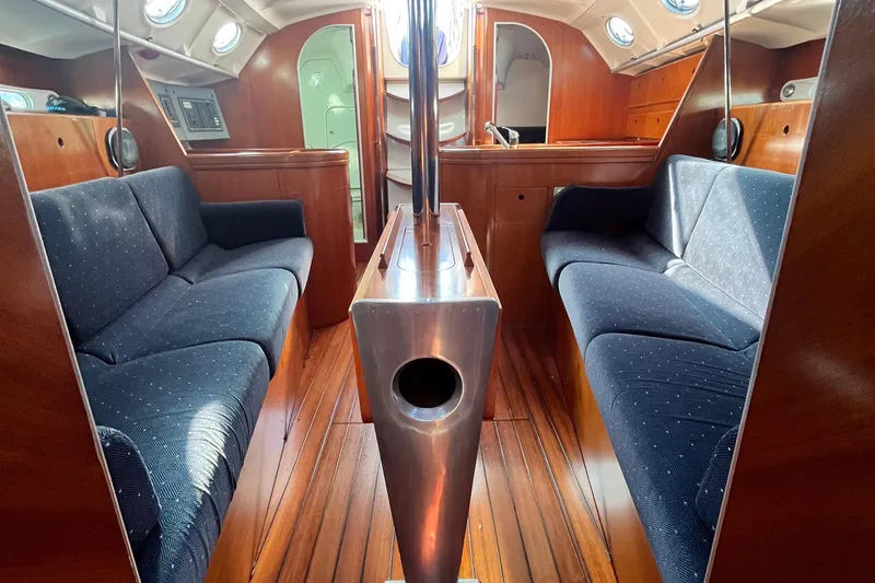 Slide: The Image of Interior of 1994 Beneteau First 35s7 yacht with wooden finish and blue seating. - 51