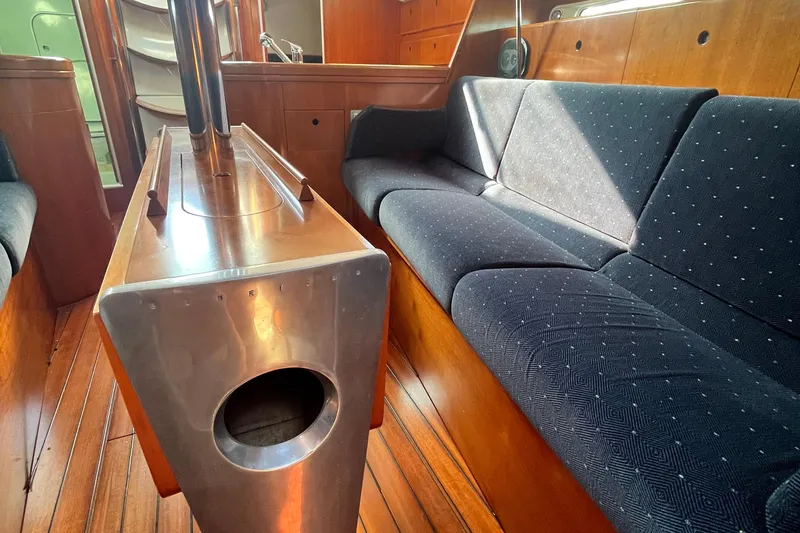 Slide: The Image of Interior of 1994 Beneteau First 35s7 yacht with wooden flooring and blue upholstered seating. - 52