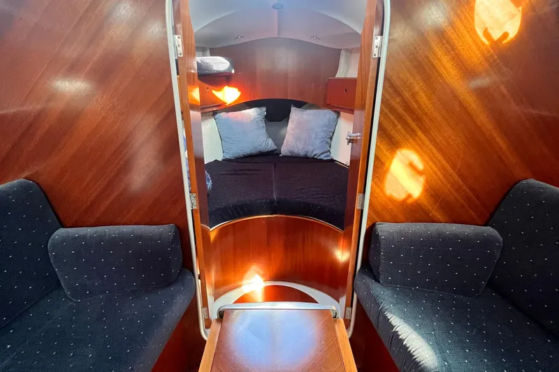 Slide: The Image of Interior of 1994 Beneteau First 35s7 sailboat with cozy cabin and wooden finish. - 54