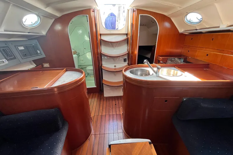 Slide: The Image of Interior of 1994 Beneteau First 35s7 yacht with wood finish and compact kitchen. - 55