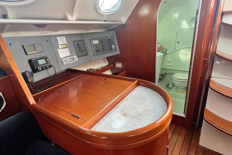 Slide: The Image of 1994 Beneteau First 35s7 yacht interior with navigation station and bathroom. - 56