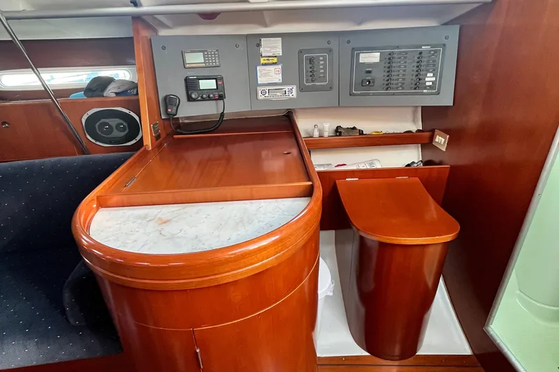 Slide: The Image of Interior of 1994 Beneteau First 35s7 yacht with navigation panel and wooden cabinetry. - 57