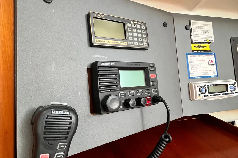 Slide: The Image of Control panel of a 1994 Beneteau First 35s7 sailboat with navigation and communication equipment. - 58