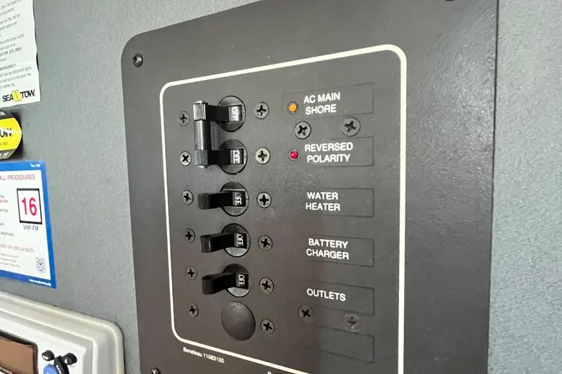 Slide: The Image of Electrical panel on a 1994 Beneteau First 35s7 sailboat, showing switches and indicators. - 59