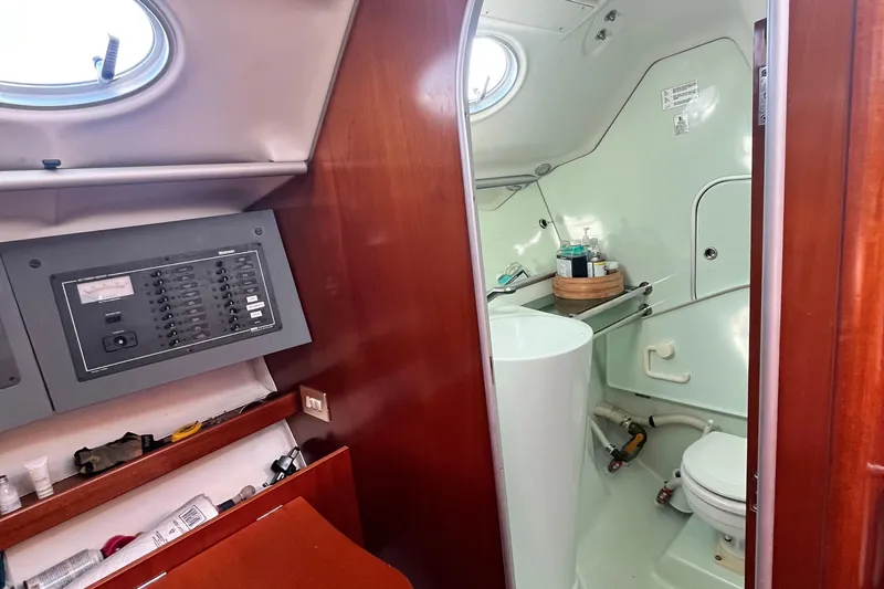 Slide: The Image of Interior of 1994 Beneteau First 35s7 yacht showing bathroom and control panel. - 61
