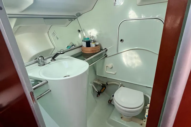 Slide: The Image of Bathroom interior of a 1994 Beneteau First 35s7 yacht, featuring sink and toilet. - 62