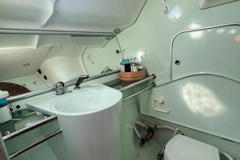 Slide: The Image of Bathroom interior of 1994 Beneteau First 35s7 yacht, featuring sink and mirror. - 64