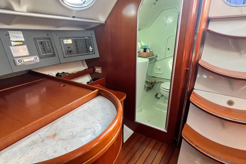 Slide: The Image of Interior of 1994 Beneteau First 35s7 yacht with navigation panel and compact bathroom. - 65