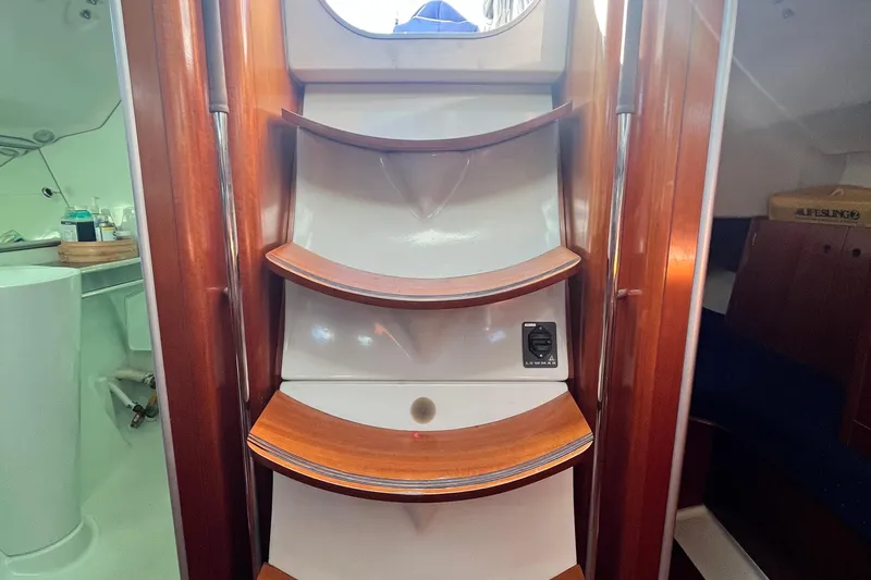 Slide: The Image of Interior view of 1994 Beneteau First 35s7 sailboat with wooden steps and cabin details. - 66