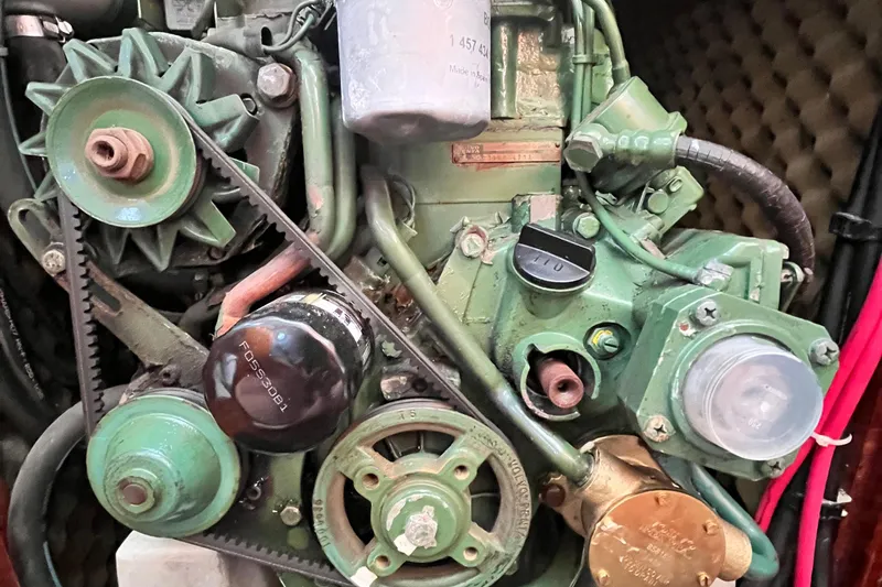 Slide: The Image of Engine components of a 1994 Beneteau First 35s7 sailboat, featuring belts and pulleys. - 71