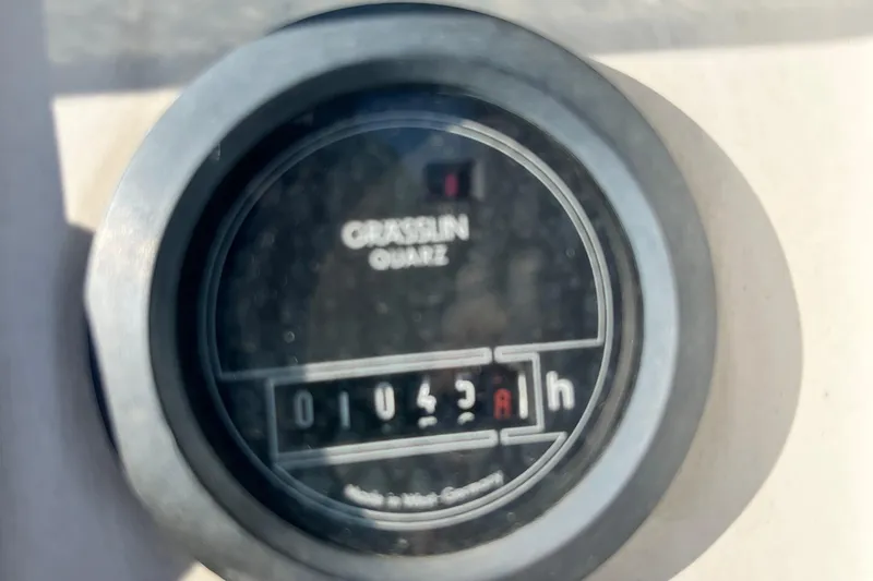 Slide: The Image of Hour meter on 1994 Beneteau First 35s7 sailboat, displaying 1043 hours. - 9