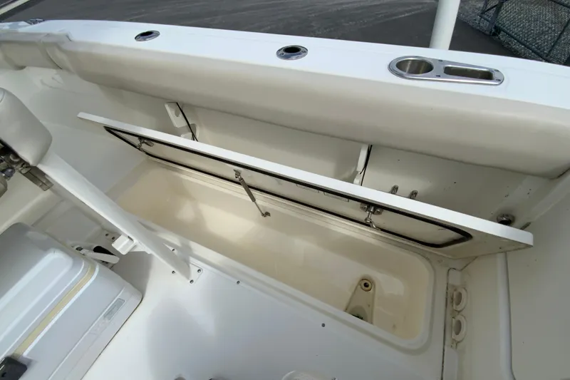 Slide: The Image of 2019 Boston Whaler 230 Outrage boat storage compartment with open lid. - 16