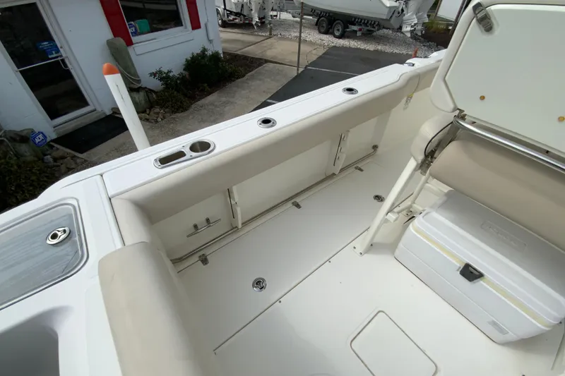 Slide: The Image of 2019 Boston Whaler 230 Outrage boat interior, featuring seating and storage compartments. - 18