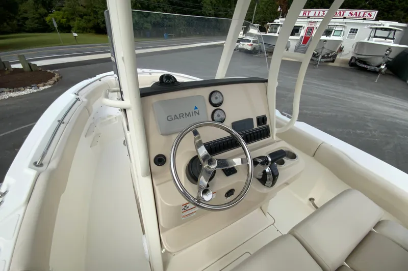 Slide: The Image of 2019 Boston Whaler 230 Outrage boat console with Garmin navigation system and steering wheel. - 22