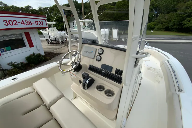 Slide: The Image of 2019 Boston Whaler 230 Outrage boat interior with steering wheel and Garmin navigation system. - 23