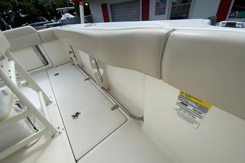 Slide: The Image of 2019 Boston Whaler 230 Outrage interior with cushioned seating and storage compartments. - 24