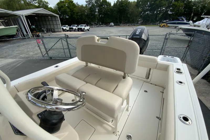 Slide: The Image of 2019 Boston Whaler 230 Outrage boat interior with steering wheel and seating. - 26