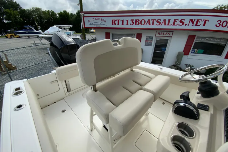 Slide: The Image of 2019 Boston Whaler 230 Outrage boat interior with helm and seating area. - 27