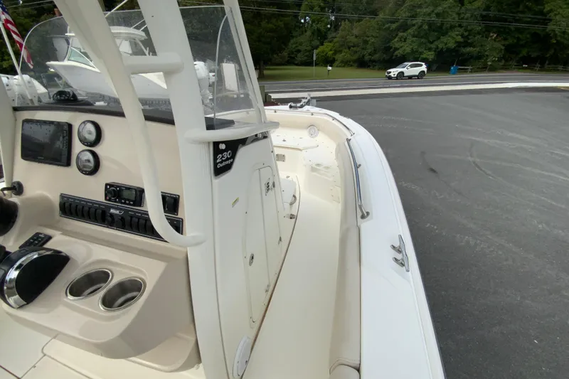 Slide: The Image of 2019 Boston Whaler 230 Outrage boat interior with control panel and seating area. - 36
