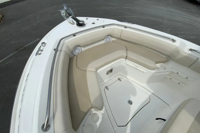 Slide: The Image of 2019 Boston Whaler 230 Outrage boat interior with cushioned seating and storage compartments. - 41