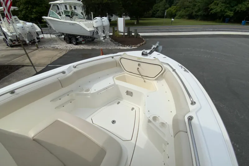 Slide: The Image of 2019 Boston Whaler 230 Outrage boat interior with seating and storage compartments. - 46