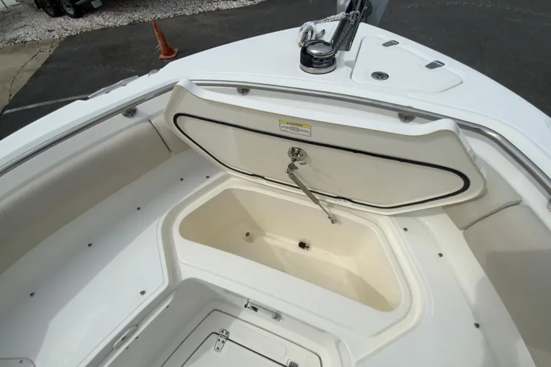 Slide: The Image of 2019 Boston Whaler 230 Outrage boat storage compartment open, showcasing interior space. - 47