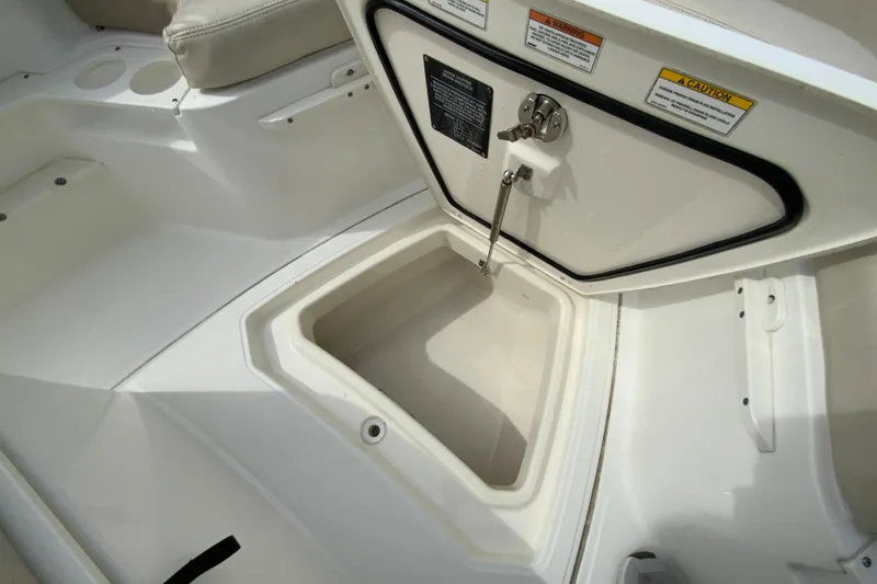 Slide: The Image of 2019 Boston Whaler 230 Outrage boat storage compartment with open hatch. - 50