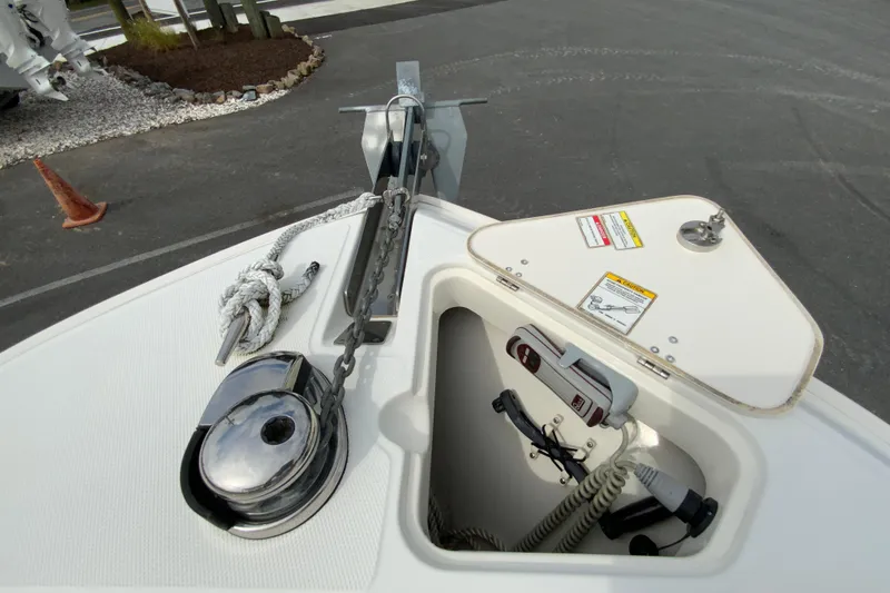 Slide: The Image of 2019 Boston Whaler 230 Outrage anchor system with storage compartment and safety labels. - 51