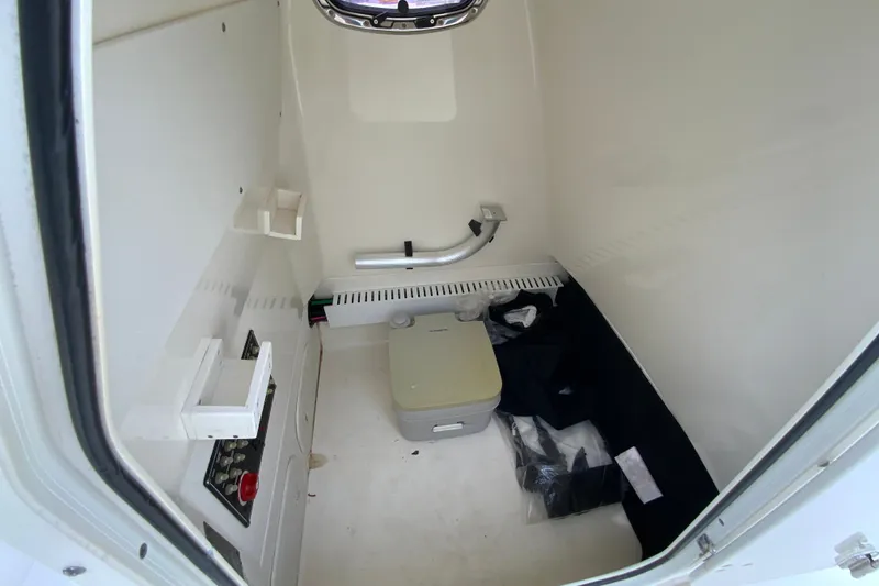 Slide: The Image of Interior of 2019 Boston Whaler 230 Outrage boat, featuring storage and equipment space. - 52