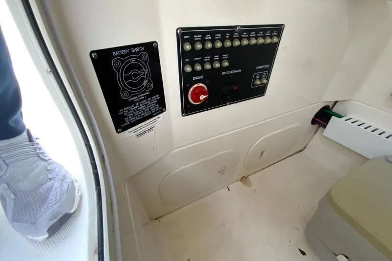Slide: The Image of 2019 Boston Whaler 230 Outrage control panel with battery switch and wiring. - 53