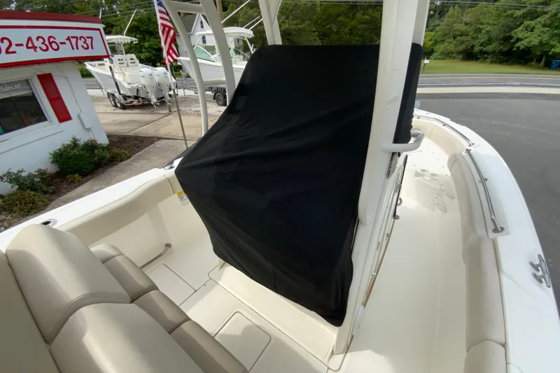 Slide: The Image of 2019 Boston Whaler 230 Outrage interior with covered console and seating. - 55