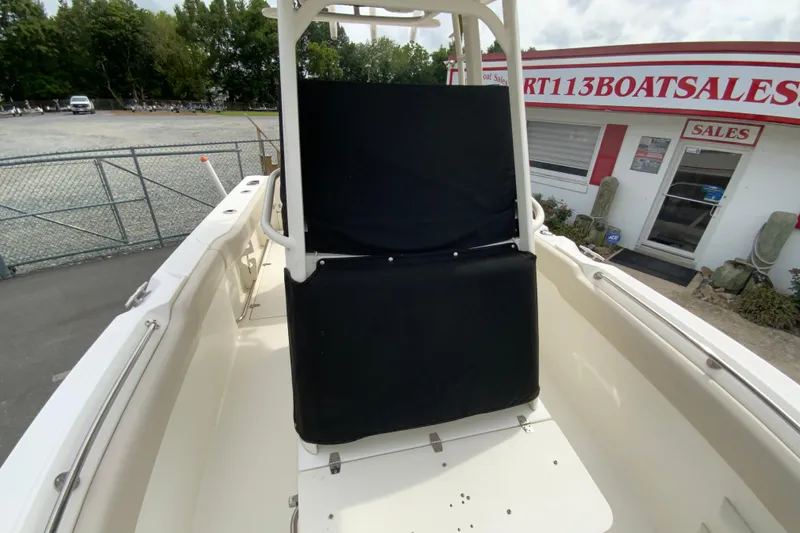 Slide: The Image of 2019 Boston Whaler 230 Outrage boat at dealership, featuring seating and console. - 56