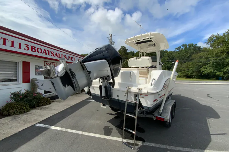 Slide: The Image of 2019 Boston Whaler 230 Outrage boat on trailer at dealership, rear view. - 8