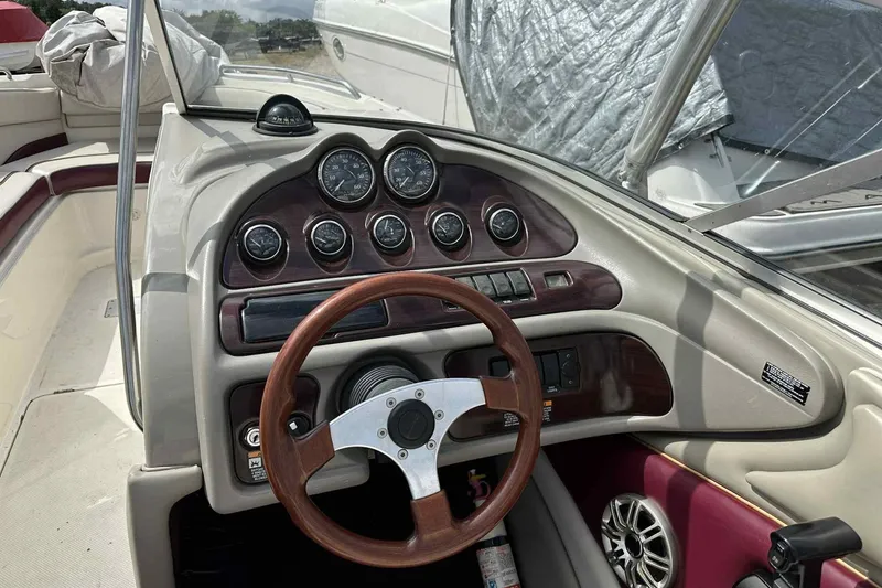 Slide: The Image of 1997 Maxum 2300 SR boat dashboard with wood accents and steering wheel. - 10
