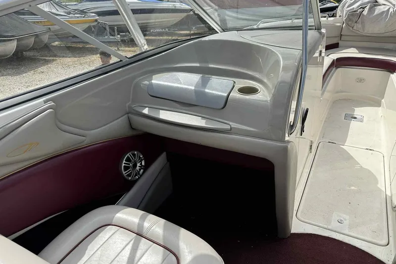 Slide: The Image of Interior of a 1997 Maxum 2300 SR boat, featuring seating and dashboard. - 11