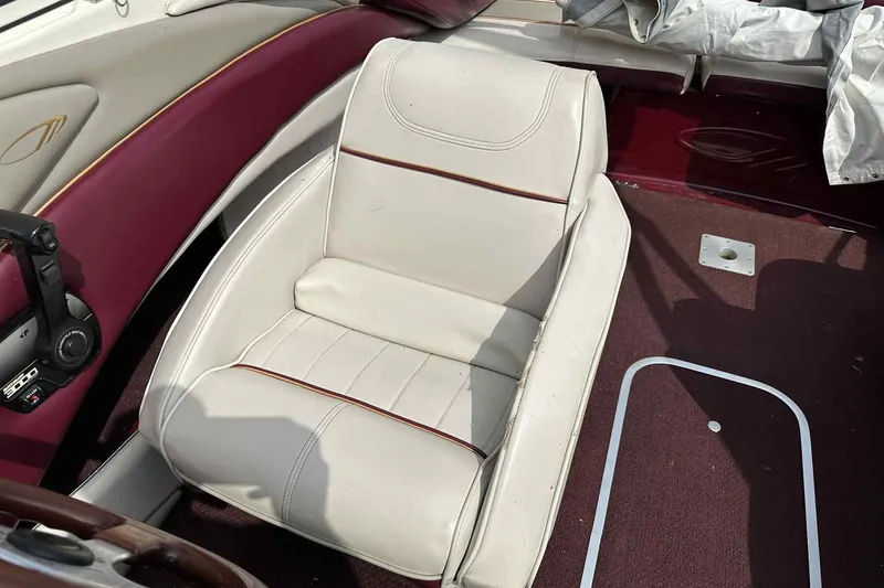 Slide: The Image of White leather seat in a 1997 Maxum 2300 SR boat interior. - 14