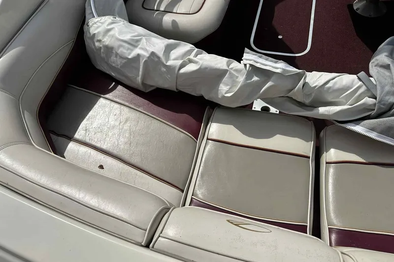 Slide: The Image of 1997 Maxum 2300 SR boat interior with white and maroon seating. - 15
