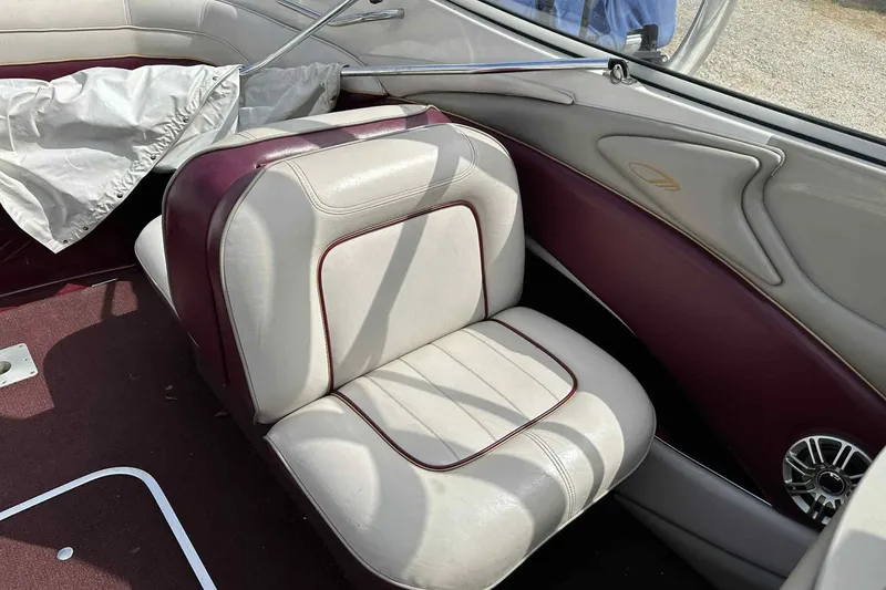 Slide: The Image of Interior of a 1997 Maxum 2300 SR boat with maroon and cream seating. - 18