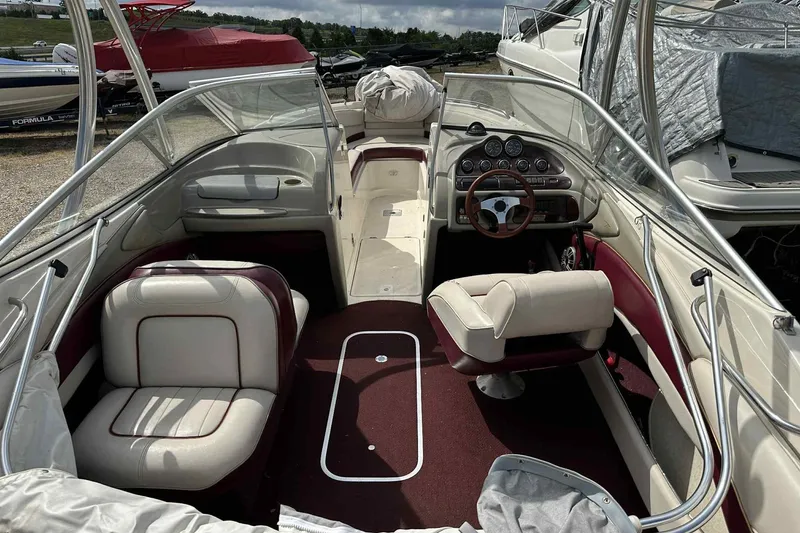 Slide: The Image of Interior of a 1997 Maxum 2300 SR boat with maroon and white seating. - 2