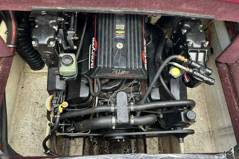 Slide: The Image of Engine compartment of a 1997 Maxum 2300 SR boat, featuring a 7.4L MerCruiser engine. - 4