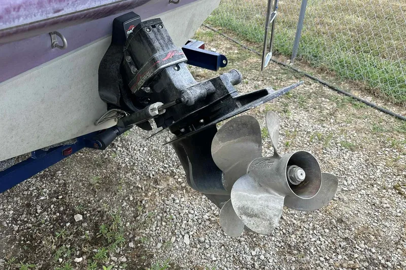 Slide: The Image of 1997 Maxum 2300 SR boat propeller and drive system on gravel surface. - 7