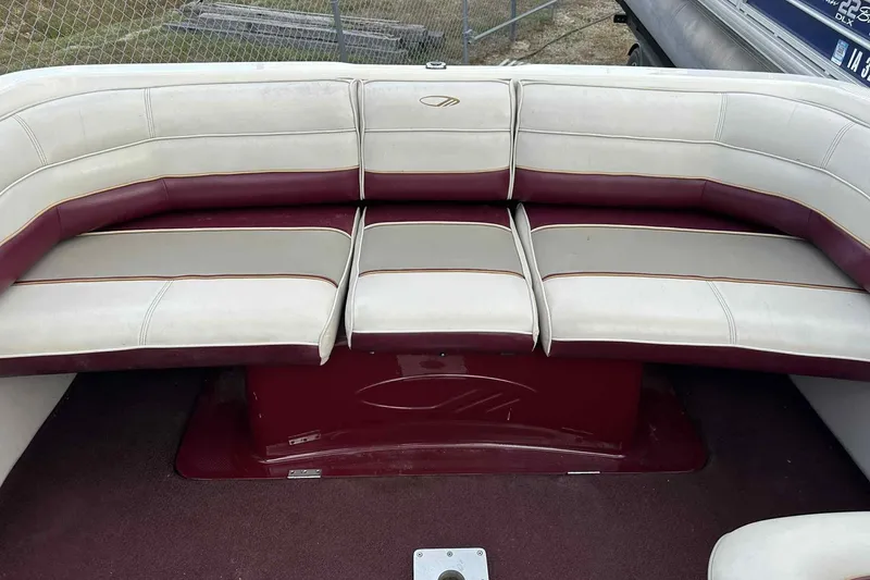 Slide: The Image of 1997 Maxum 2300 SR boat interior with maroon and white seating arrangement. - 8