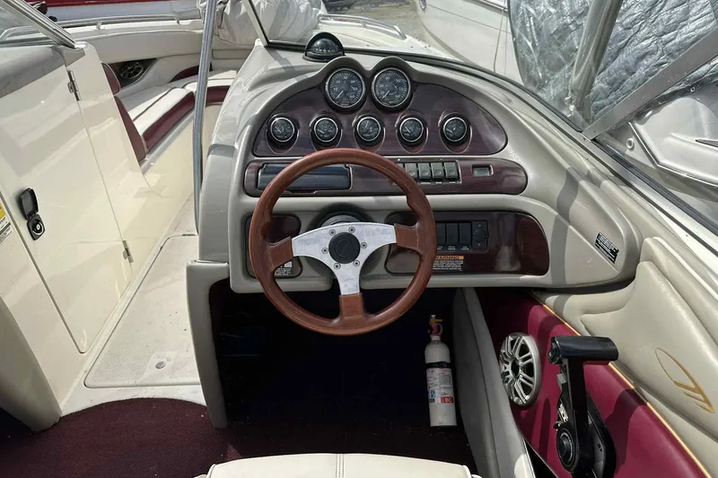 Slide: The Image of 1997 Maxum 2300 SR boat dashboard with steering wheel and gauges. - 9