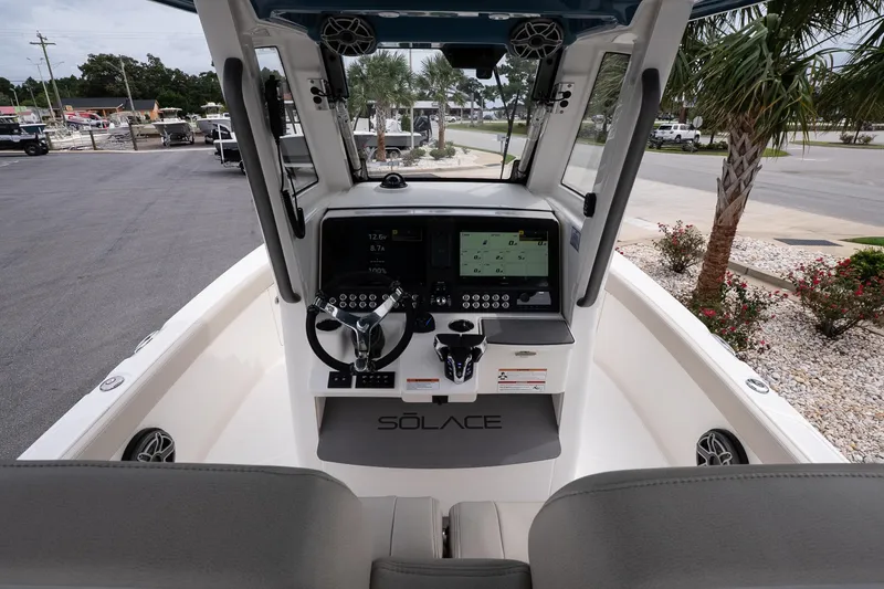 Slide: The Image of 2026 Solace 28 HCS boat cockpit with modern controls and steering wheel. - 18
