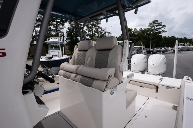 Slide: The Image of 2026 Solace 28 HCS boat interior with dual seats and outboard motors. - 23