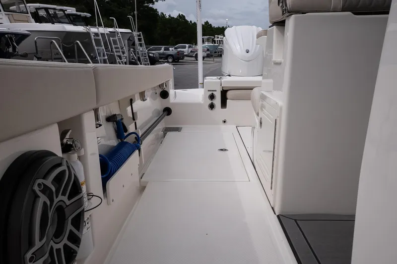 Slide: The Image of Interior view of 2026 Solace 28 HCS boat, featuring seating and storage compartments. - 30