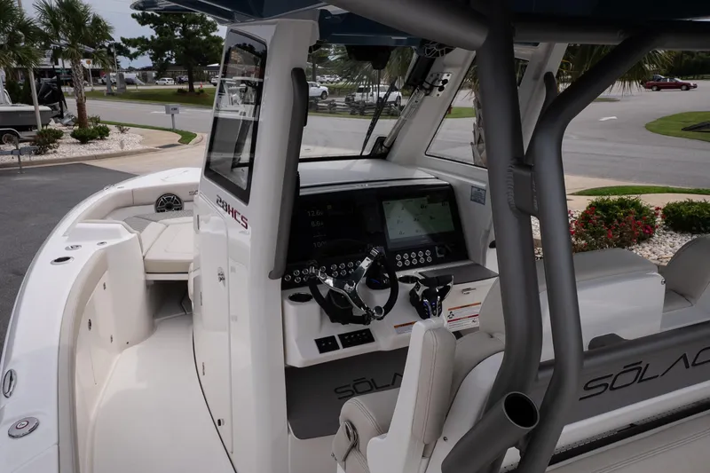 Slide: The Image of 2026 Solace 28 HCS boat interior with advanced navigation system and seating. - 32