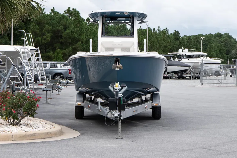 Slide: The Image of 2026 Solace 28 HCS boat on trailer in marina parking lot. - 4